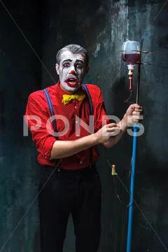 The scary clown and drip with blood on dack background. Halloween concept Stock Photos