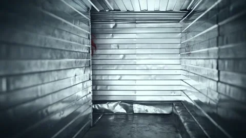 Scary clown attacks in a closed ventilation duct. Scary psychopath in a suit. Video stock 194990542