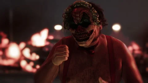 Scary clown gesturing thumbs up in front of fire at night Stock Footage 296240927