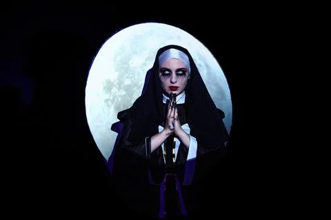 Scary devil nun with full moon background. Halloween concept Stock Photos