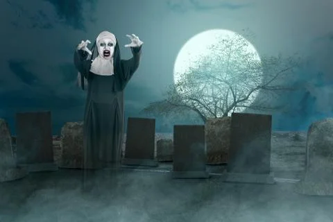 Scary devil nun standing on the graveyard Stock Photos