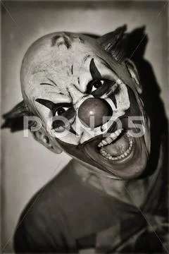 Scary evil clown in sepia toning Stock Photos
