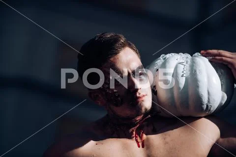 Scary face man with horror Make up holding Pumpkin head jack lantern. Close-up Stock Photos