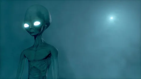 Scary gray alien standing and blinking at the dark foggy background of a moon Stock Footage 273033079