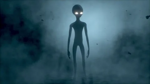 Scary gray alien stands and looks blinking on a dark smoky background. UFO Stock Footage 278602219