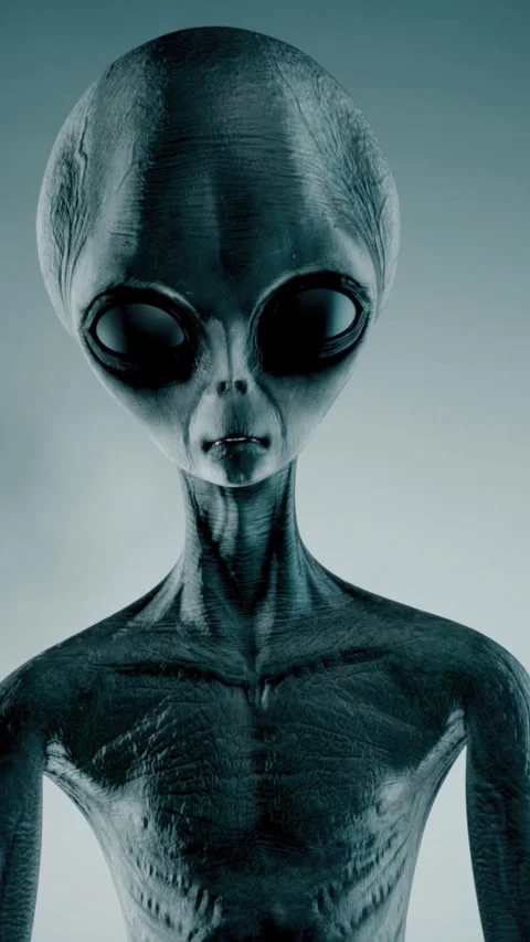 Scary gray alien stands and looks blinking on a dark smoky background. UFO Stock Footage 310963738