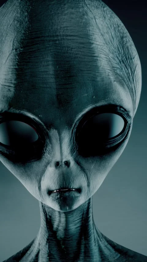 Scary gray alien stands and looks blinking on a dark smoky background. UFO Stock Footage 310963741