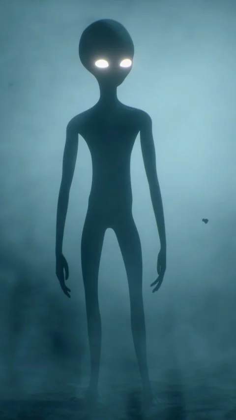 Scary gray alien stands and looks blinking on a dark smoky background. UFO 스톡 동영상 310963778