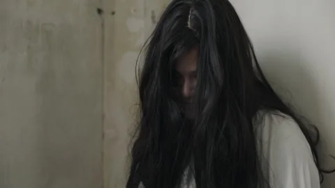 Scary halloween devil ghost with black long disheveled hair and white costume 動画素材 343826853