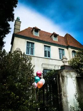 Scary horror gable orange tile roof building with fireplace chimney and balloons 스톡 사진