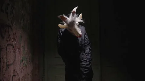 Scary masked person having an attack, shaking in a haunted house. Stock Footage 145920253