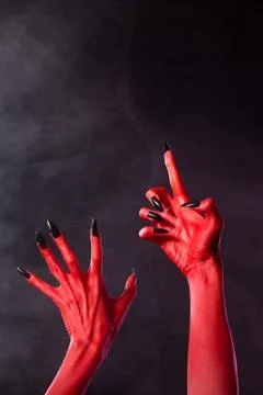 Scary red devil hands with black nails 스톡 사진