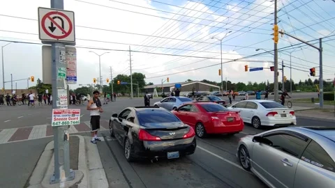 Scary scene of young men blocking road for clandestine car show parade Stock Footage 136854315