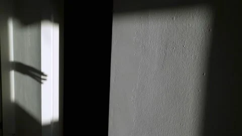 Scary shadow of the hand on the wall. The hand is crawling along the wall Video stock 146383087
