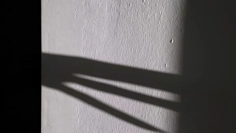 Scary shadow of the hand on the wall. The hand is crawling along the wall Stockbeeldmateriaal 146445181