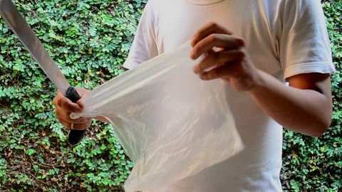 Scary sharp slaughter blade test plastic bag slicing Stock Footage 118955066