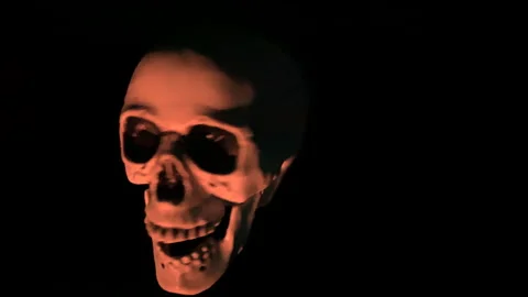 Scary Skeleton Head Appears From The Darkness Video stock 172257196