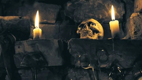 Scary skull in place for rituals with instruments and candles Video stock 80796274