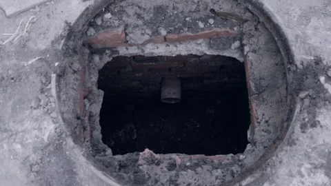 Scary video of going down into an old sewer collector or manhole with a pipe Stock Footage 306879731