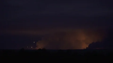 Scary war zone from the distance with explosions and projectiles in the smoke Stock Footage 97054839