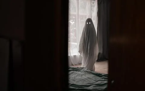 Scary white ghost made from a sheet in an abandoned house. Halloween concept Stock Photos