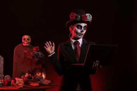 Scary woman using laptop on dios de los muertos Stock Photos