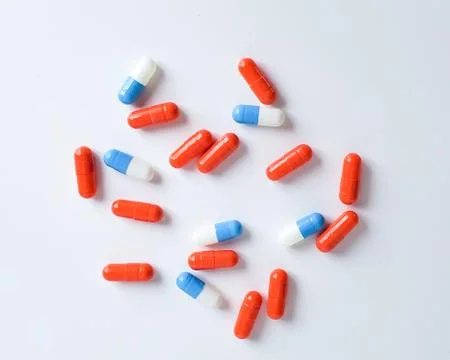 Scattered capsules on a white background. Stock Photos