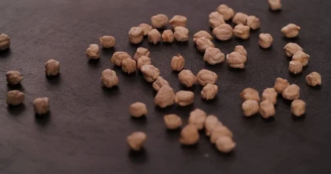 Scattered Chickpea on rotating table surface 4K video background Stock Footage 108779689