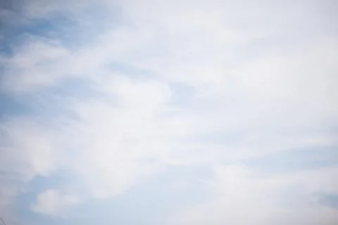 Scattered cloud clusters in a blue sky, blue sky background with white clouds Stock Photos