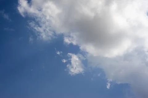 Scattered cloud clusters in a blue sky, blue sky background with white clouds Stock Photos