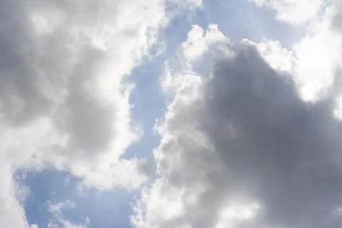 Scattered cloud clusters in a blue sky, blue sky background with white clouds Stock Photos