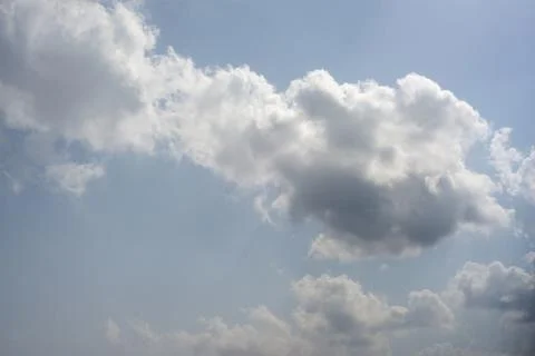 Scattered cloud clusters in a blue sky, blue sky background with white clouds Stock Photos