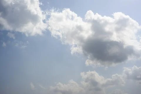 Scattered cloud clusters in a blue sky, blue sky background with white clouds Stock Photos