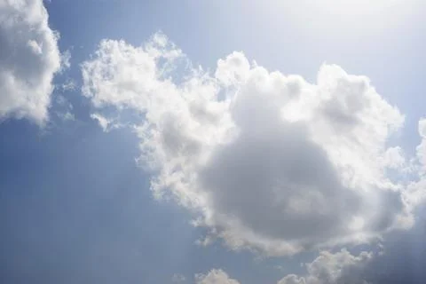 Scattered cloud clusters in a blue sky, blue sky background with white clouds Stock Photos