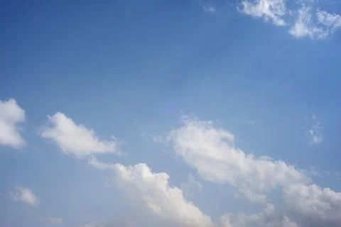 Scattered cloud clusters in a blue sky, blue sky background with white clouds 스톡 사진