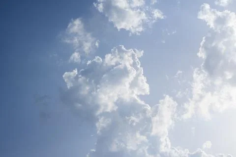 Scattered cloud clusters in a blue sky, blue sky background with white clouds Foto stock