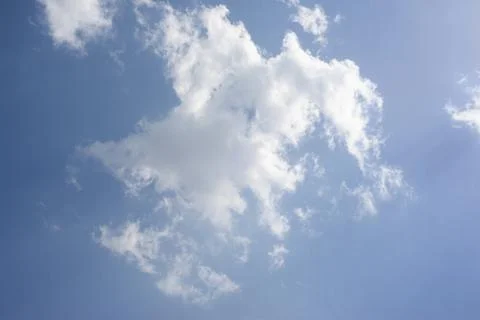 Scattered cloud clusters in a blue sky, blue sky background with white clouds Stock Photos