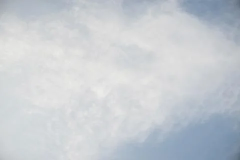 Scattered cloud clusters in a blue sky, blue sky background with white clouds Stock Photos