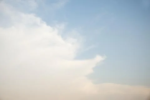 Scattered cloud clusters in a blue sky, blue sky background with white clouds 库存照片