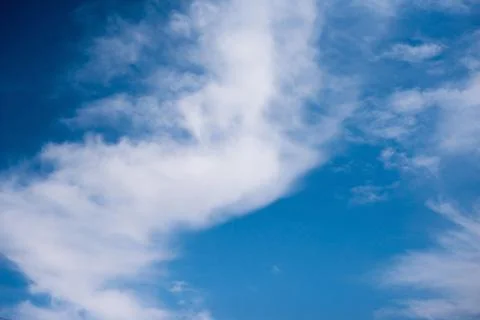 Scattered cloud clusters in a blue sky, blue sky background with white clouds Stock Photos