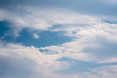 Scattered cloud clusters in a blue sky, blue sky background with white clouds Foto stock