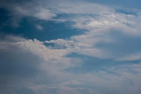 Scattered cloud clusters in a blue sky, blue sky background with white clouds Stock Photos