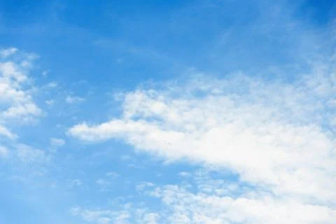 Scattered cloud clusters in a blue sky, blue sky background with white clouds Stock Photos