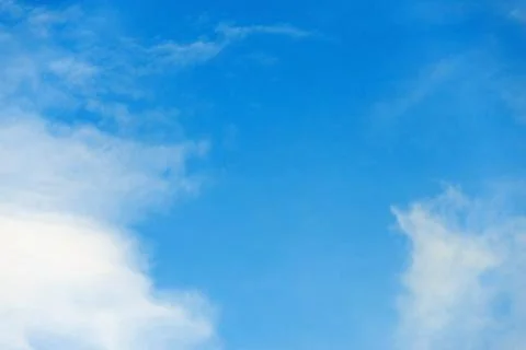 Scattered cloud clusters in a blue sky, blue sky background with white clouds Stock Photos