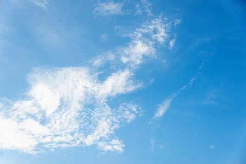 Scattered cloud clusters in a blue sky, blue sky background with white clouds Stock Photos