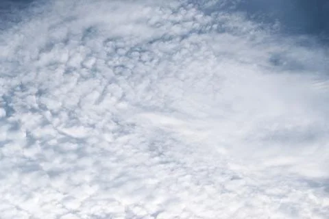Scattered cloud clusters in a blue sky, blue sky background with white clouds Stock Photos