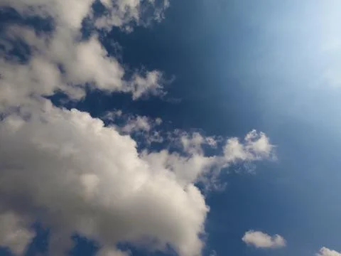 Scattered cloud clusters in a blue sky, blue sky background with white clouds 스톡 사진