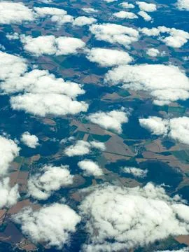 Scattered clouds above patchwork fields during a clear day in early afterno.. 스톡 사진