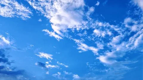 Scattered Clouds in Bright Blue Sky Background Stock Photos