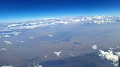 Scattered Clouds Over Arid Terrain Below Vídeo Stock 334402055
